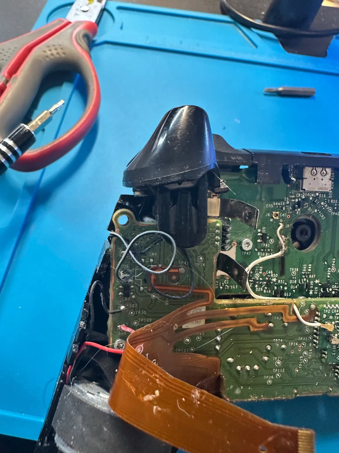 Detailed electronics repair work at the FlexRepairs bench